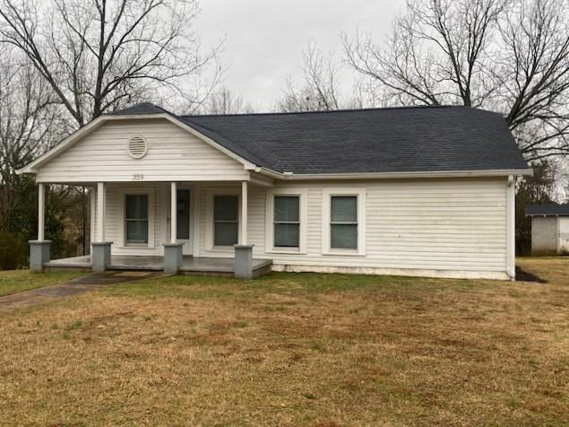 view of front of house featuring covered porch and a front lawn