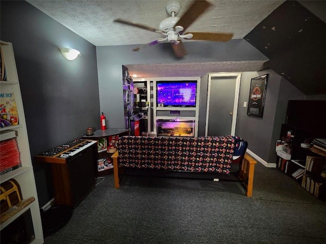 interior space featuring a textured ceiling, a ceiling fan, and baseboards