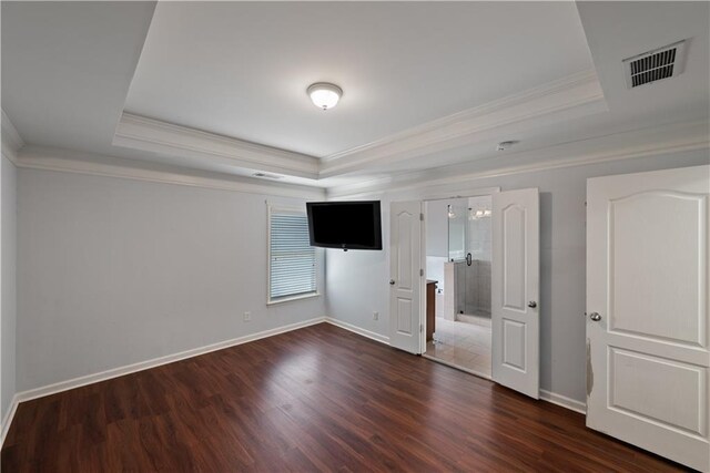 unfurnished bedroom featuring a raised ceiling, crown molding, baseboards, and dark wood-type flooring