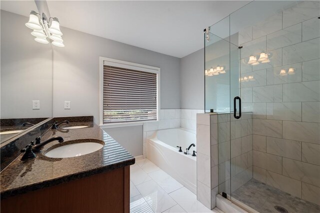 bathroom featuring a garden tub, a stall shower, and double vanity