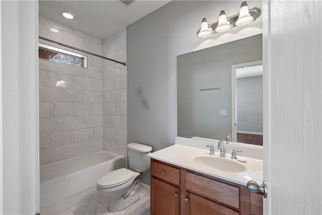 bathroom with toilet, vanity, and tub / shower combination