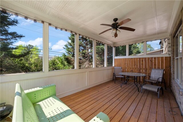 sunroom / solarium featuring a ceiling fan and plenty of natural light