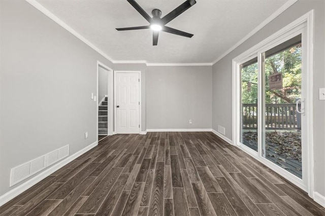 spare room featuring dark wood-type flooring, visible vents, ceiling fan, and baseboards
