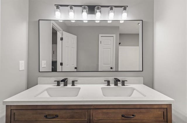 bathroom featuring double vanity and a sink