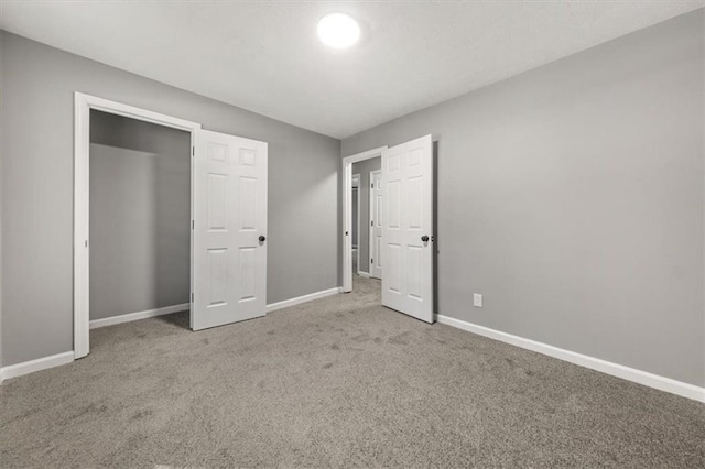 unfurnished bedroom featuring carpet floors and baseboards