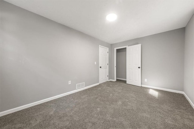 unfurnished bedroom featuring visible vents, baseboards, and carpet floors