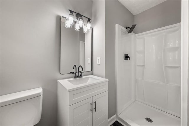 full bath featuring a shower stall, vanity, and toilet