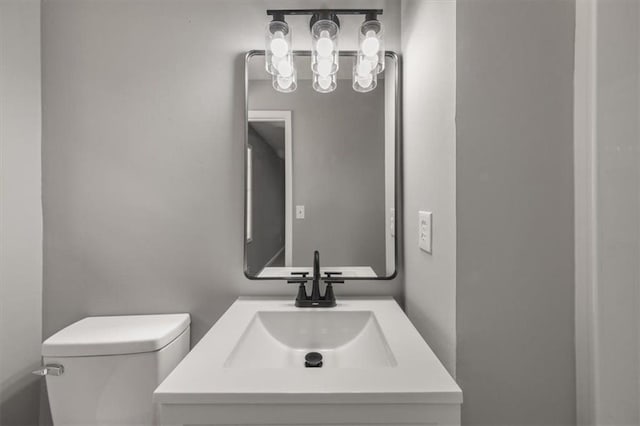 bathroom featuring toilet and vanity