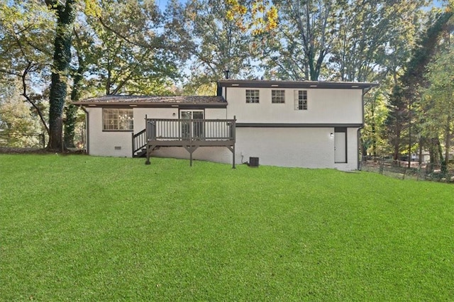 back of house featuring brick siding, fence, a deck, and a lawn