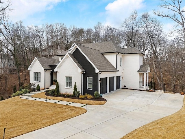 view of front of house featuring driveway, a front lawn, fence, a shingled roof, and a garage