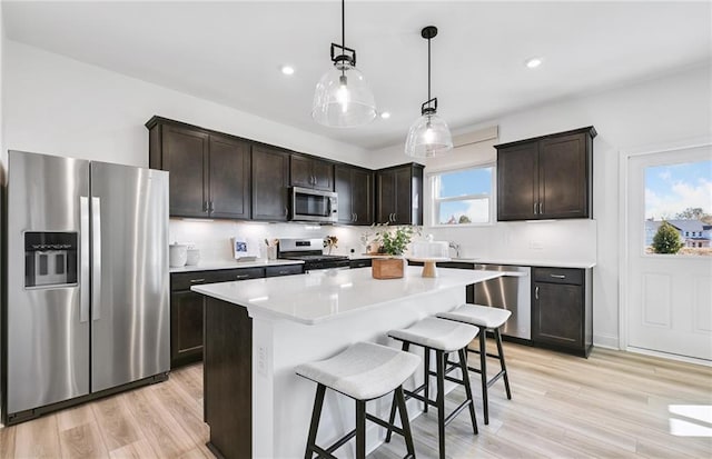 126 Jane Blvd NW, Cartersville, GA 30120 - kitchen with stainless steel appliances, dark brown cabinets, a kitchen breakfast bar, and recessed lighting