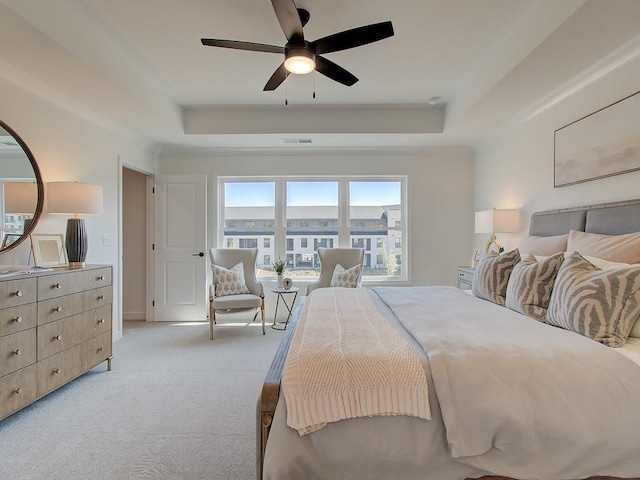 living room featuring ceiling fan, light hardwood / wood-style floors, crown molding, and a fireplace