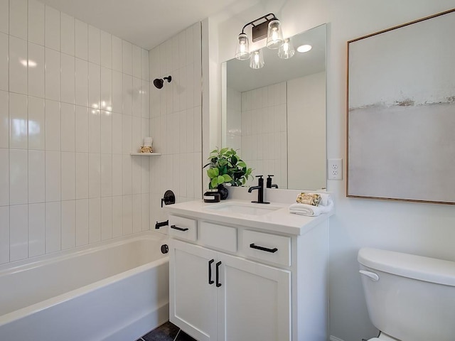 full bathroom featuring tiled shower / bath combo, toilet, and vanity