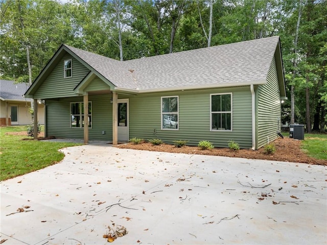 ranch-style house with roof with shingles and central air condition unit