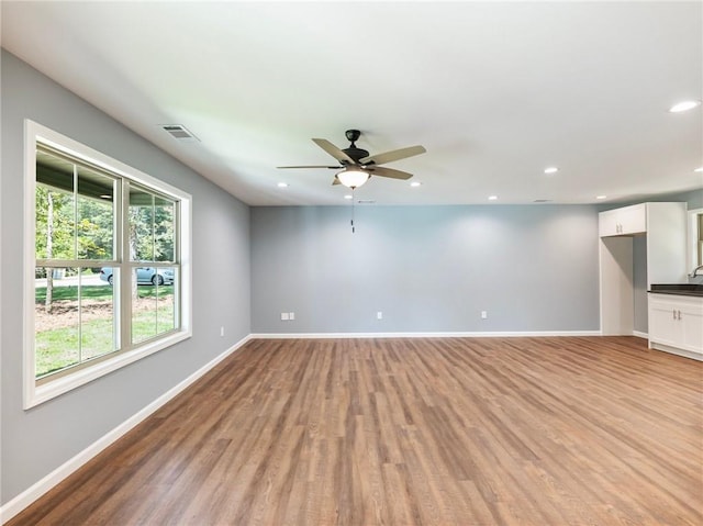 unfurnished room with recessed lighting, visible vents, light wood finished floors, and baseboards