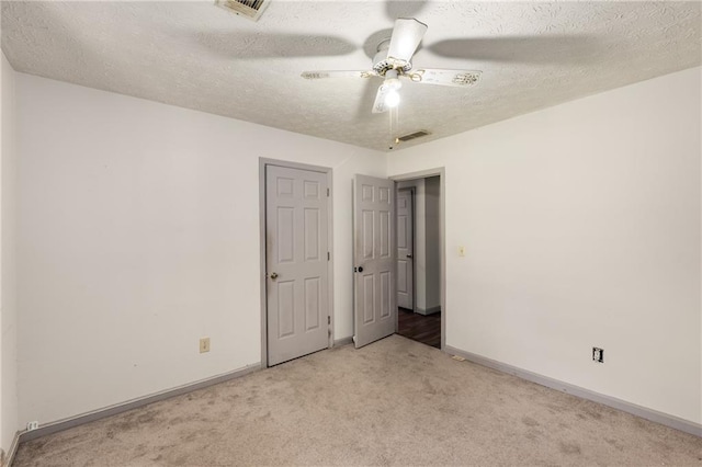 2617 Laurel Woods Ln SE, Conyers, GA 30094 - unfurnished bedroom featuring carpet floors, a textured ceiling, and a ceiling fan