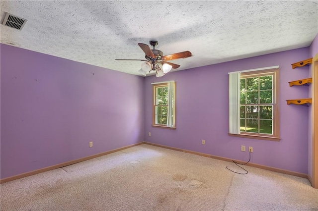 2617 Laurel Woods Ln SE, Conyers, GA 30094 - spare room featuring healthy amount of natural light, ceiling fan, carpet, and a textured ceiling