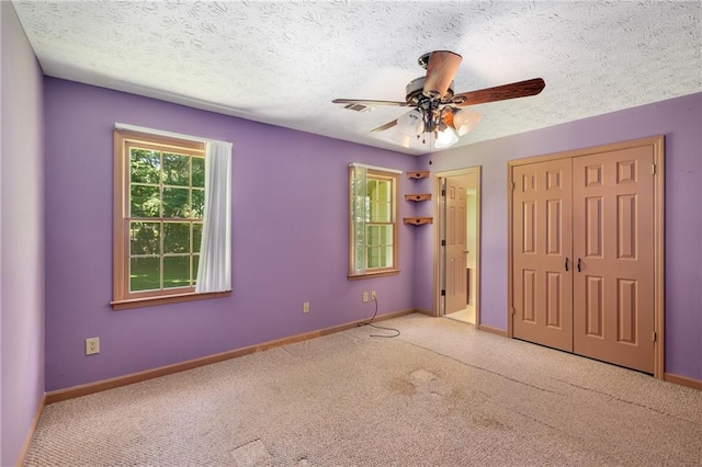 2617 Laurel Woods Ln SE, Conyers, GA 30094 - unfurnished bedroom with carpet, a textured ceiling, and a ceiling fan