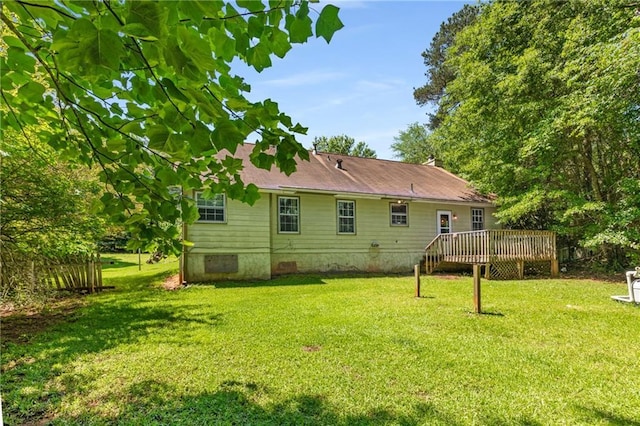 2617 Laurel Woods Ln SE, Conyers, GA 30094 - rear view of property featuring a wooden deck, a lawn, and crawl space