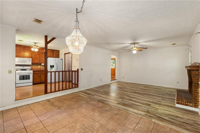 2617 Laurel Woods Ln SE, Conyers, GA 30094 - unfurnished living room with ceiling fan, light wood-style flooring, a chandelier, a textured ceiling, and a fireplace