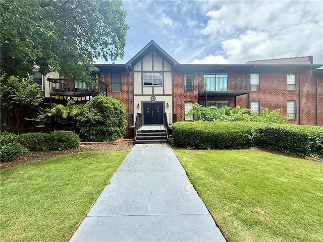 6851 Roswell Rd Unit D33, Atlanta, GA 30328 - tudor house featuring brick siding and a front lawn