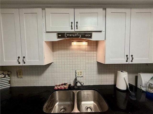 6851 Roswell Rd Unit D33, Atlanta, GA 30328 - kitchen featuring a sink, decorative backsplash, and white cabinetry
