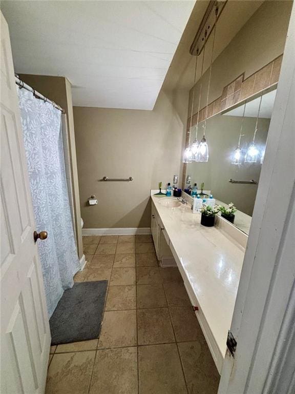 6851 Roswell Rd Unit D33, Atlanta, GA 30328 - full bath featuring double vanity, toilet, baseboards, and tile patterned floors