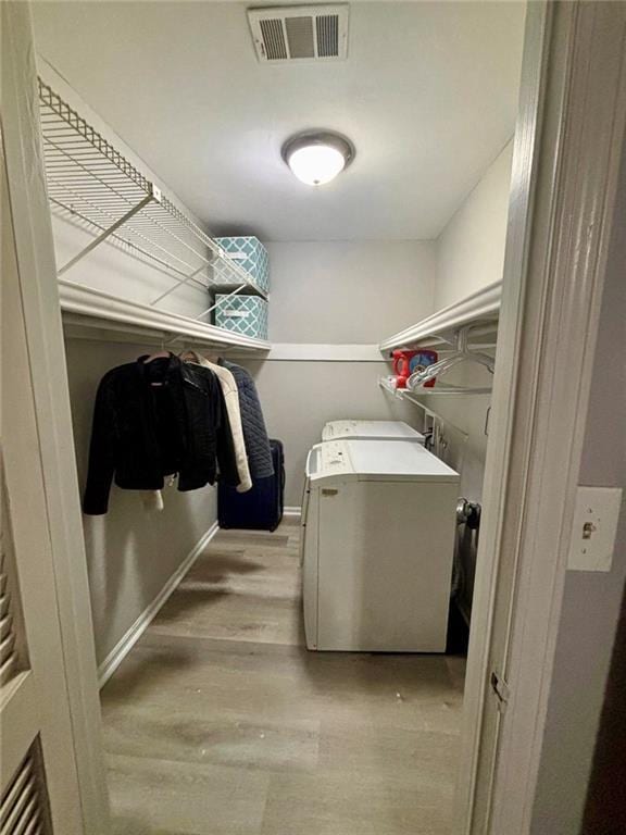 6851 Roswell Rd Unit D33, Atlanta, GA 30328 - laundry area with light wood-type flooring, baseboards, and separate washer and dryer