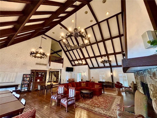 6851 Roswell Rd Unit D33, Atlanta, GA 30328 - living room with a chandelier, high vaulted ceiling, hardwood / wood-style floors, a fireplace, and beam ceiling