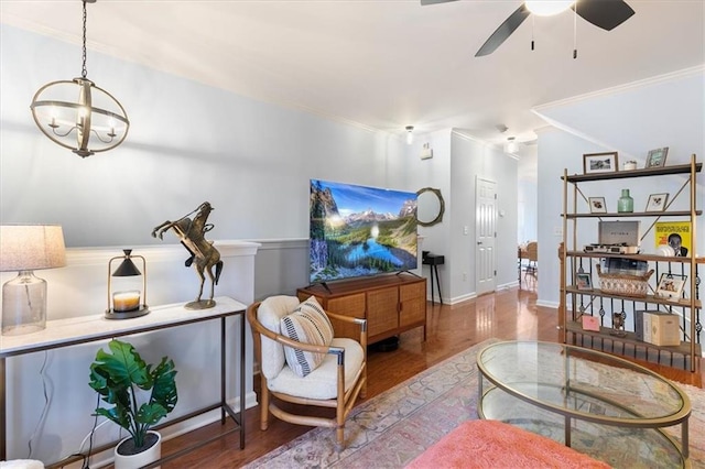 interior space with ceiling fan with notable chandelier, hardwood / wood-style flooring, and ornamental molding