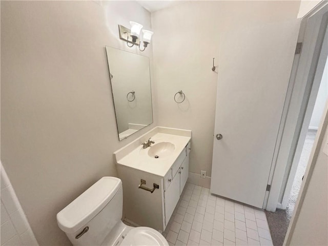 bathroom with tile patterned floors, vanity, and toilet