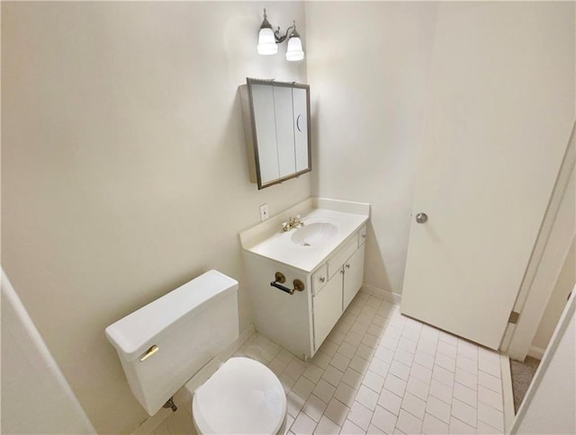 bathroom with vanity, tile patterned flooring, and toilet