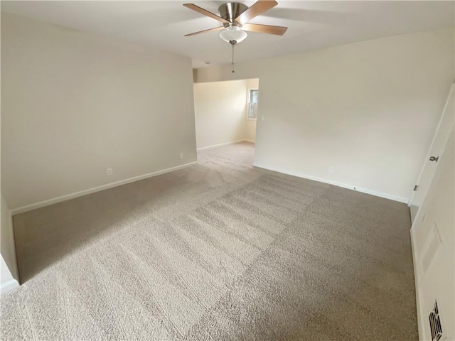 carpeted spare room with ceiling fan