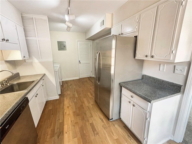 kitchen featuring sink, stainless steel appliances, washer / clothes dryer, light hardwood / wood-style floors, and white cabinets