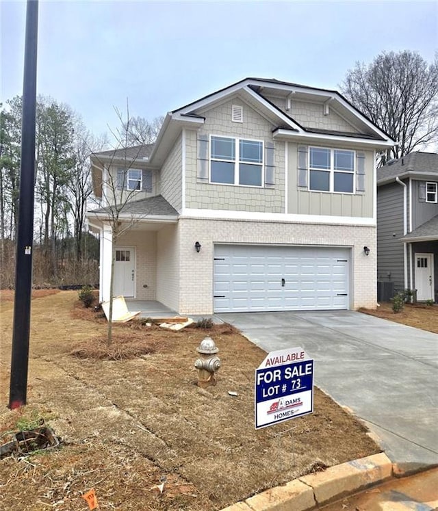 view of front of house featuring cooling unit and a garage