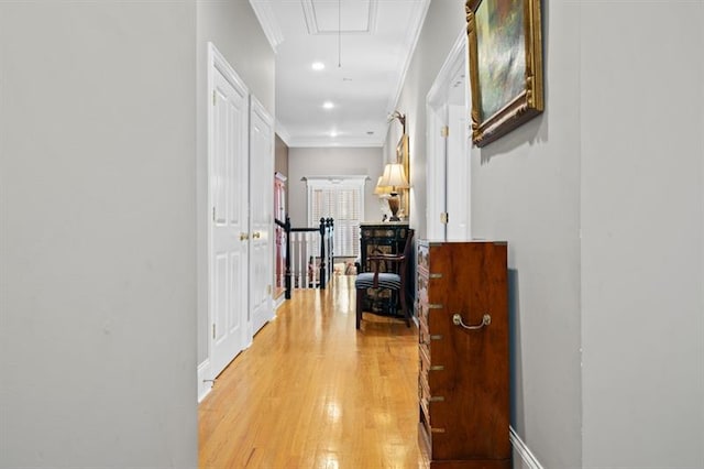 hall featuring crown molding and light hardwood / wood-style floors