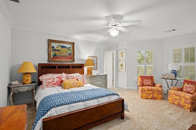 carpeted bedroom with ceiling fan and ornamental molding