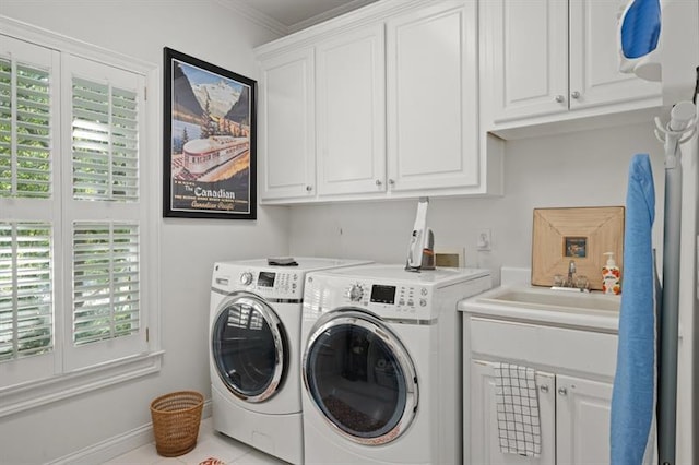 laundry area featuring a healthy amount of sunlight, cabinets, separate washer and dryer, and crown molding