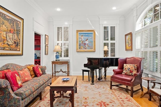 sitting room with light hardwood / wood-style flooring and crown molding