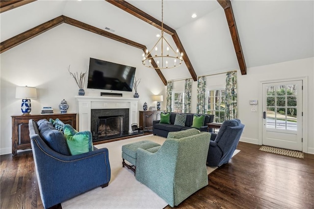 living room featuring baseboards, a premium fireplace, beam ceiling, and wood finished floors