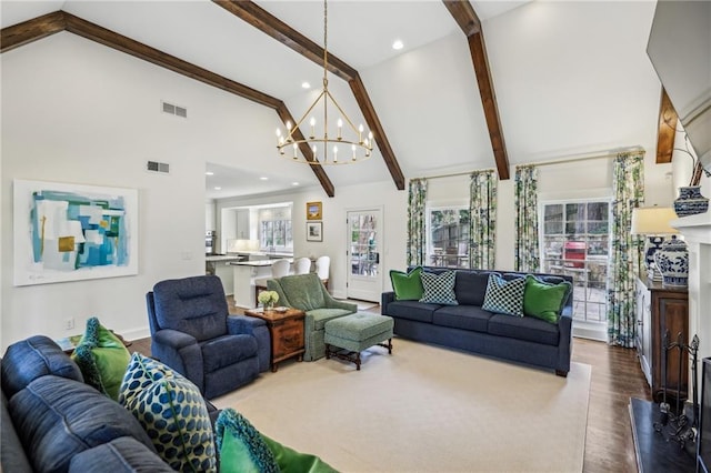 living room with a chandelier, beam ceiling, and visible vents