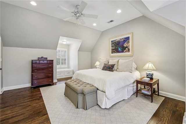 bedroom featuring vaulted ceiling, wood finished floors, visible vents, and baseboards