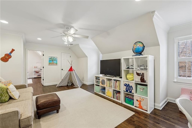 living area with baseboards, lofted ceiling, ceiling fan, ornamental molding, and dark wood-style flooring