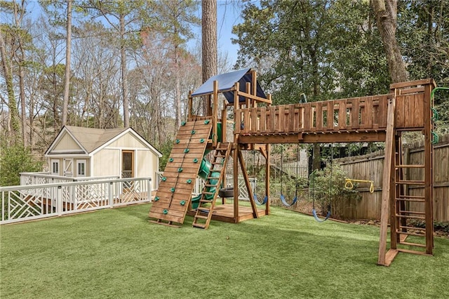 view of jungle gym featuring fence and a lawn