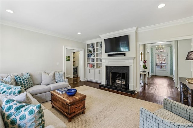 living area featuring a fireplace with raised hearth, ornamental molding, dark wood finished floors, and recessed lighting