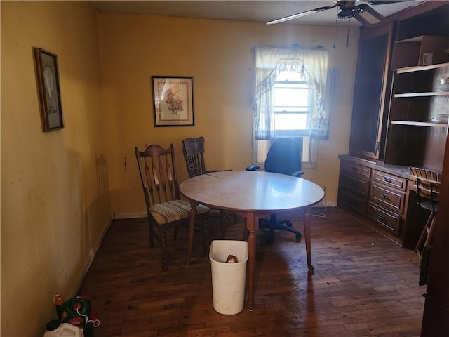 dining room with ceiling fan and dark hardwood / wood-style flooring