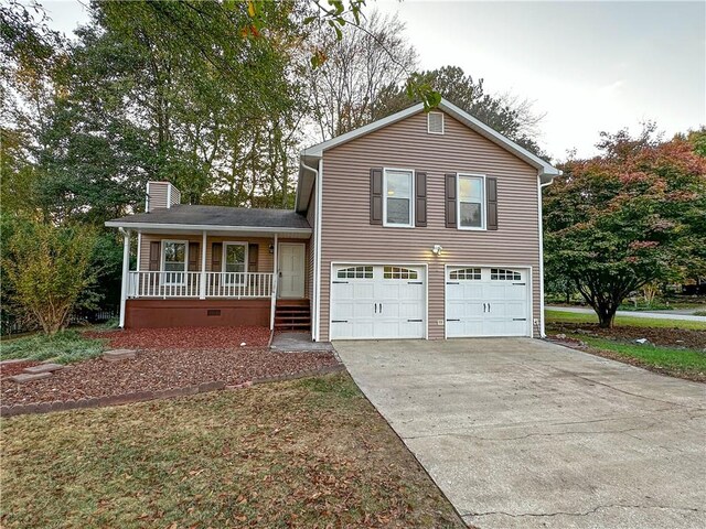 tri-level home with covered porch and a garage