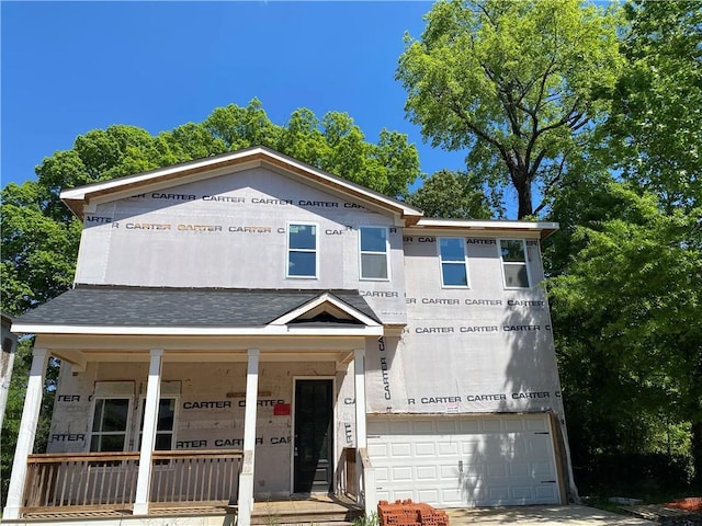 property under construction featuring covered porch and a garage