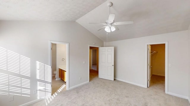 364 Springhaven Way, Lawrenceville, GA 30046 - unfurnished bedroom featuring a walk in closet, light carpet, lofted ceiling, a closet, and ceiling fan
