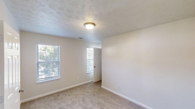 364 Springhaven Way, Lawrenceville, GA 30046 - unfurnished room featuring healthy amount of natural light, light colored carpet, and a textured ceiling